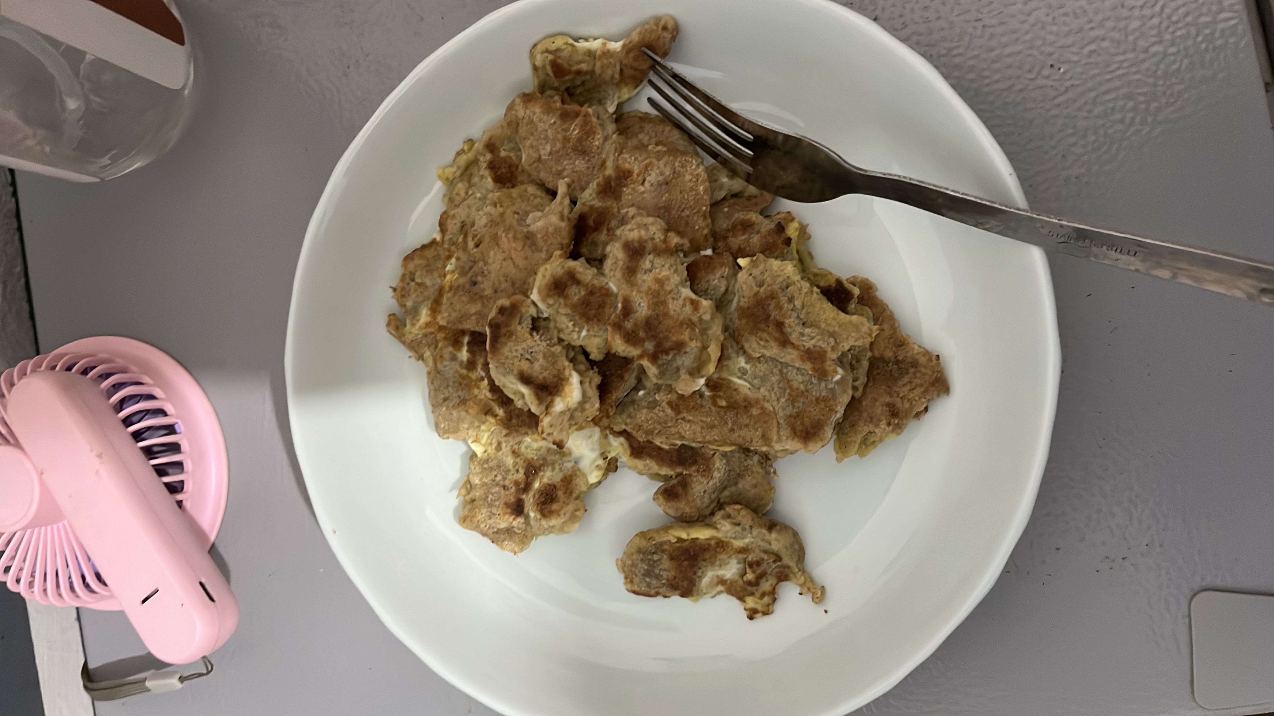 A homemade egg-based dish with a browned exterior, likely containing whole wheat flour and cooked with oil.