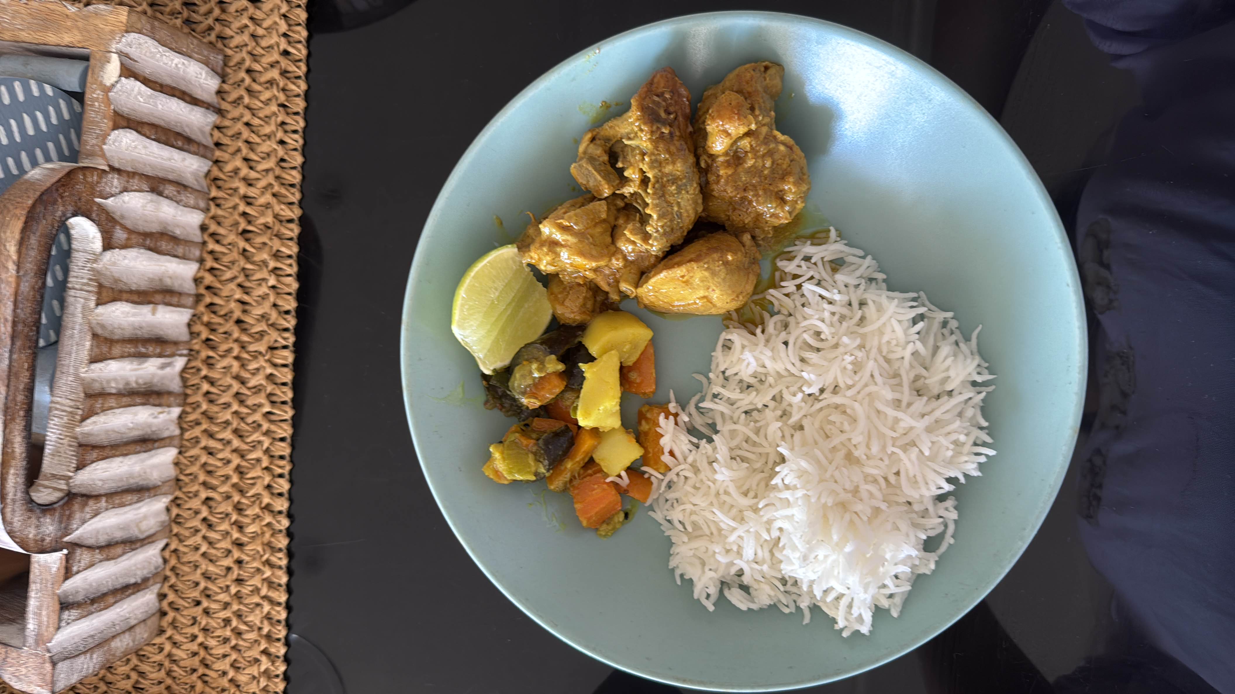 A balanced meal consisting of basmati rice, chicken curry, and mixed vegetables, providing a good mix of protein, carbohydrates, and fats.