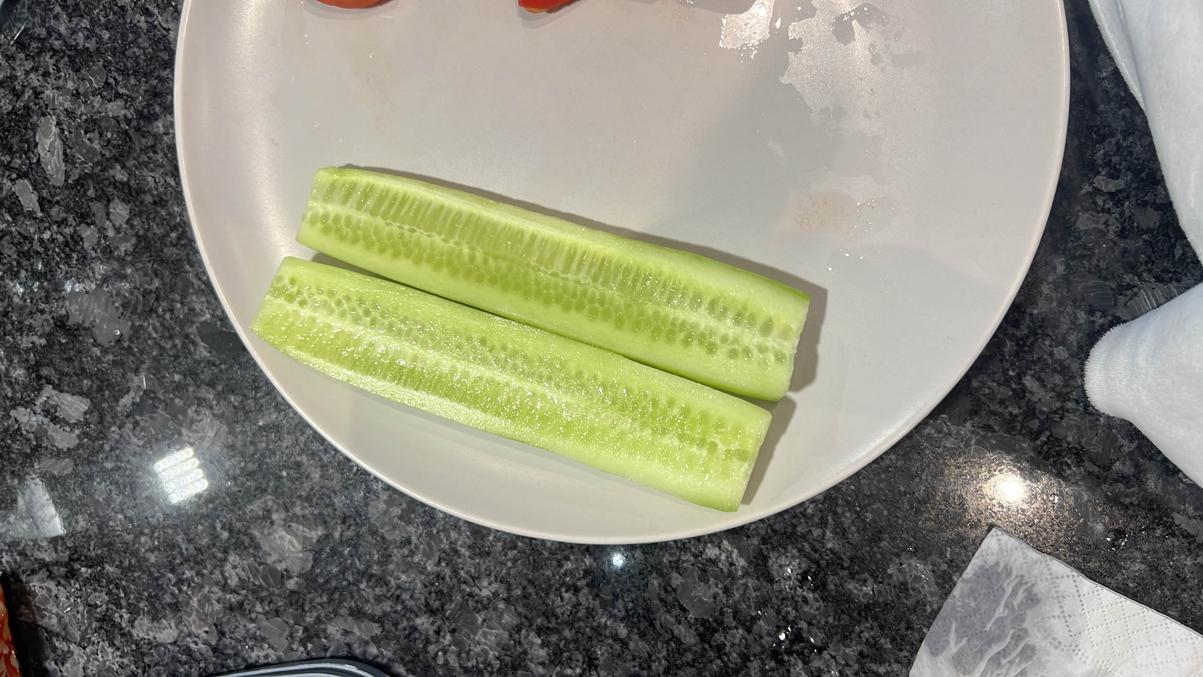 The image shows sliced cucumber on a plate, which is a low-calorie, hydrating vegetable rich in fiber and essential nutrients.