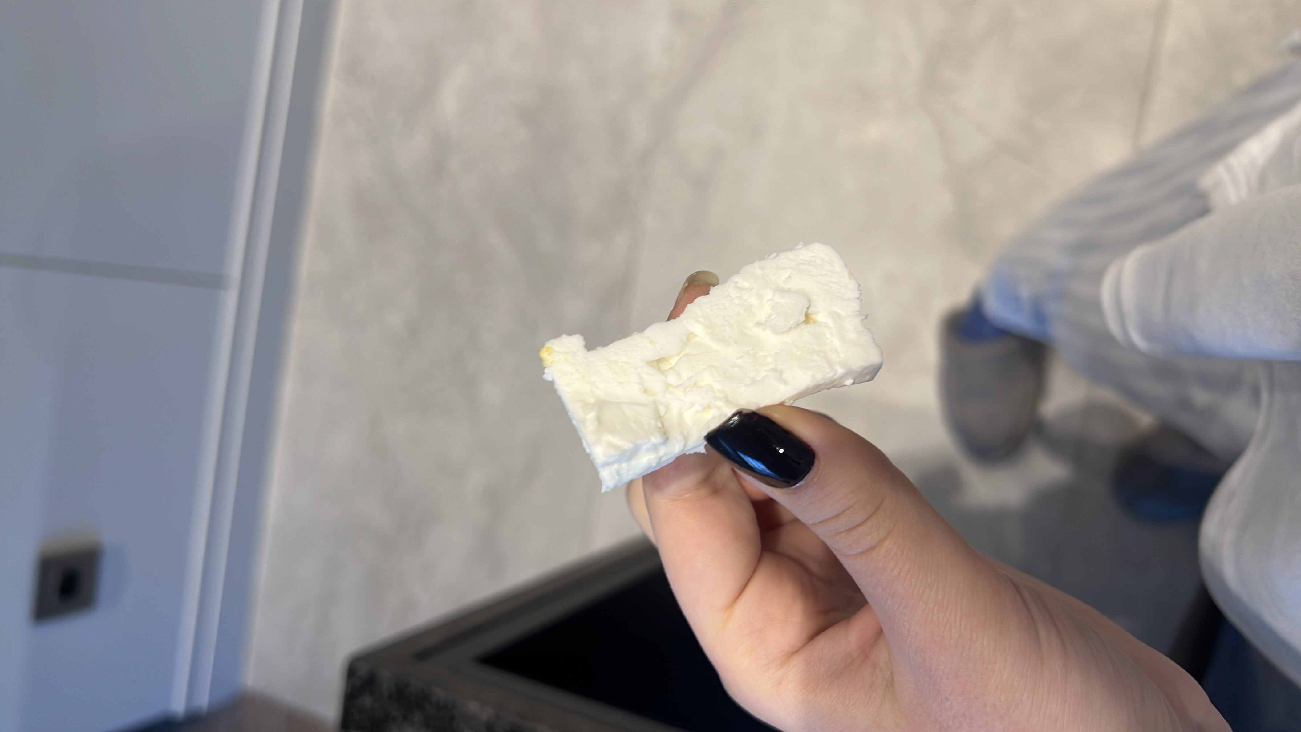 A piece of feta cheese, which is a rich source of protein and fats with minimal carbohydrates.