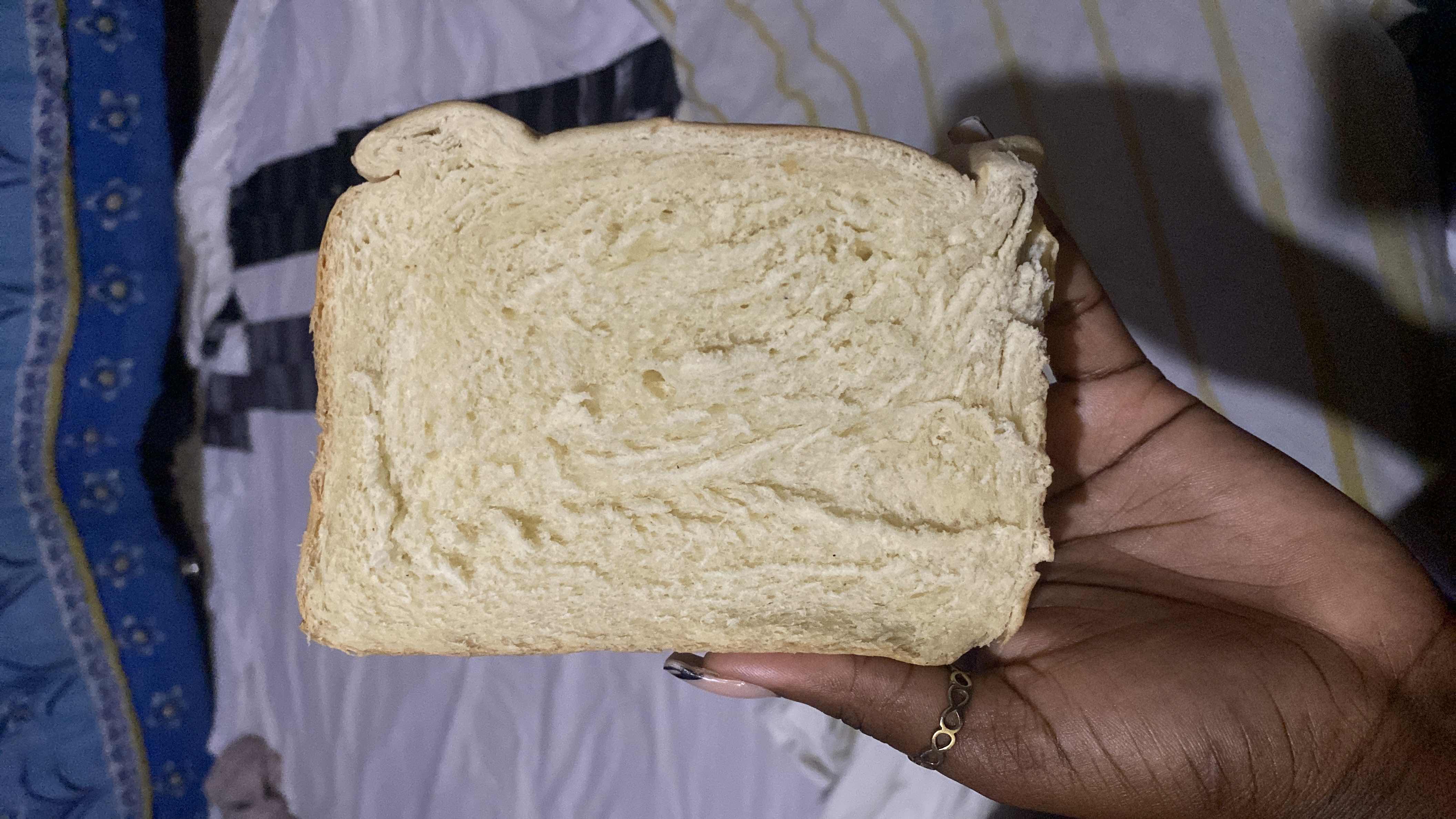 A slice of white bread, which is a common source of carbohydrates with moderate protein and low fat content.