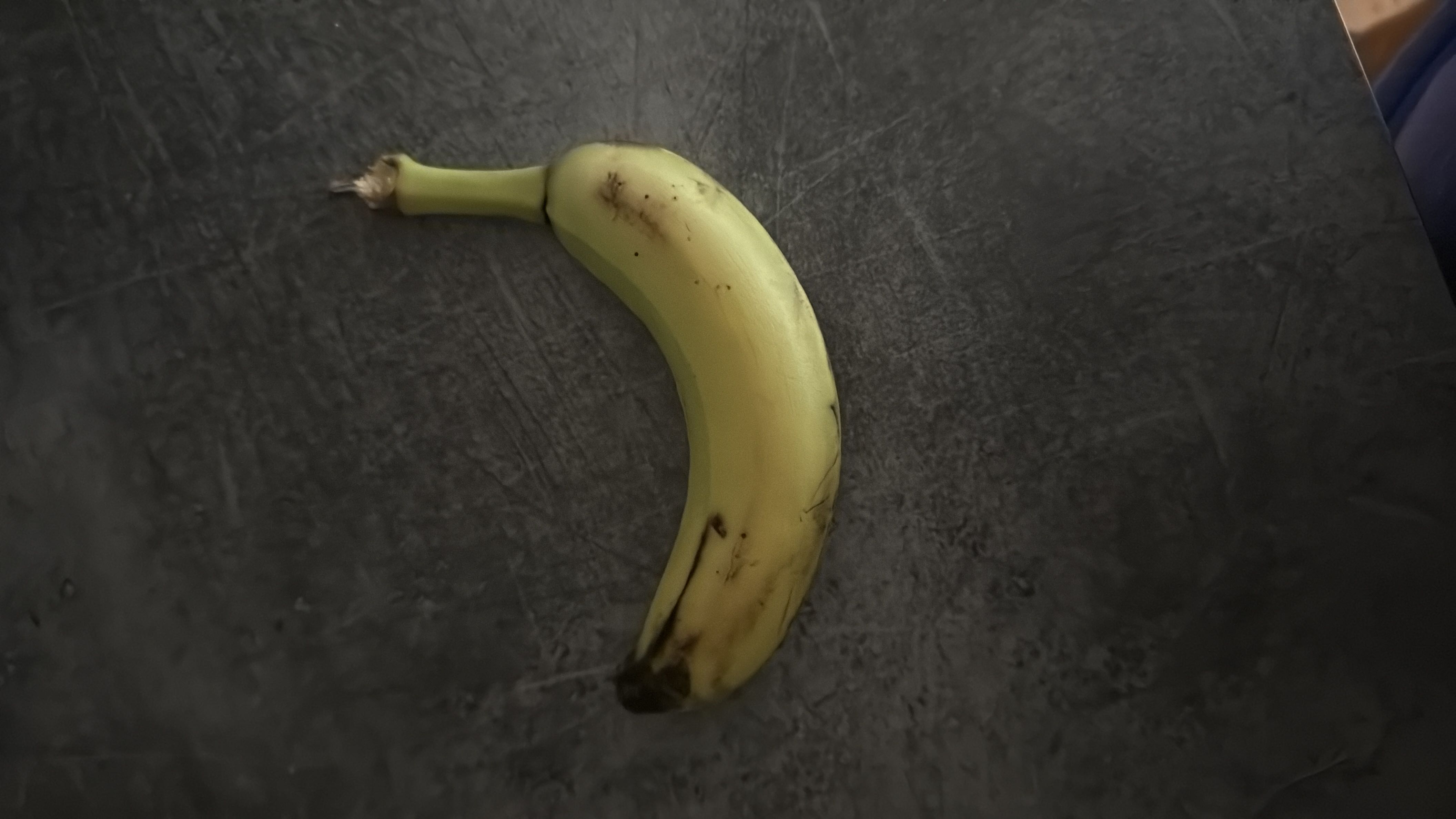 A ripe banana, rich in carbohydrates and low in fats, providing a good source of energy and essential nutrients.