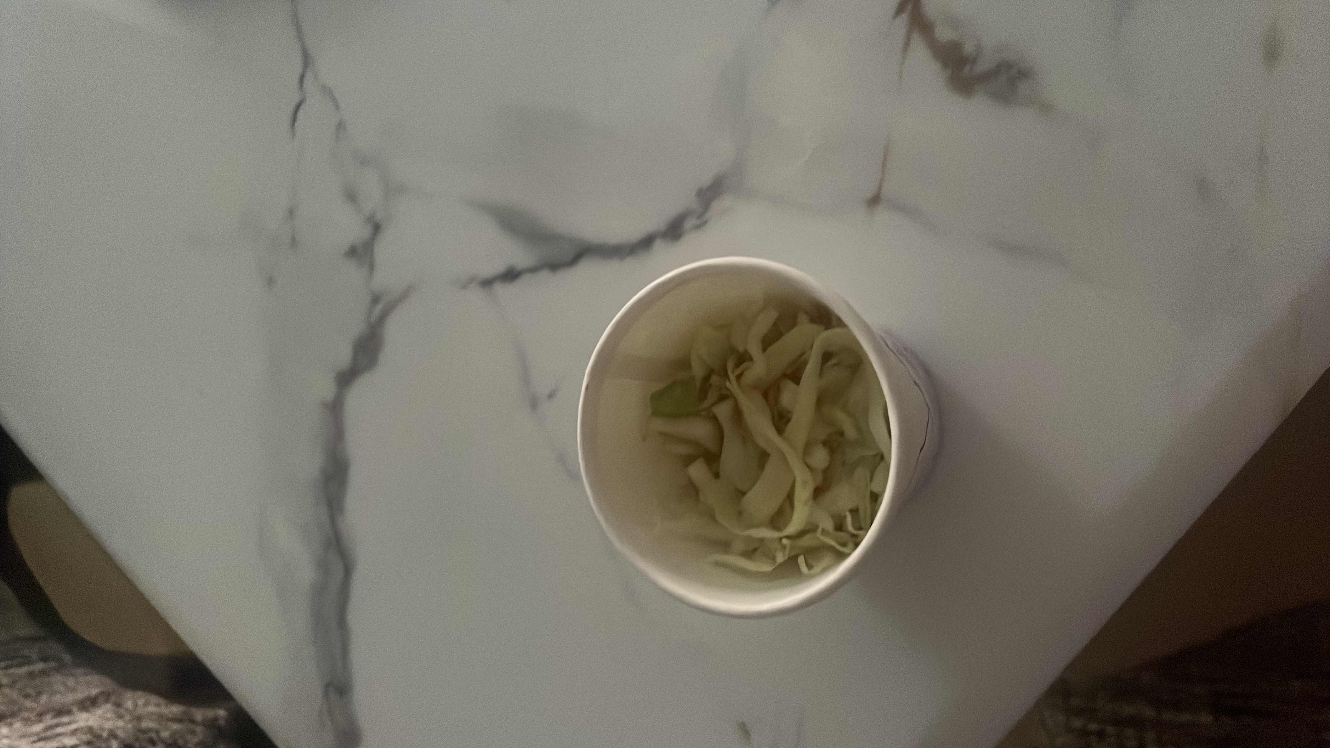 A light and healthy dish containing shredded cabbage and noodles, providing a low-calorie and nutritious meal option.