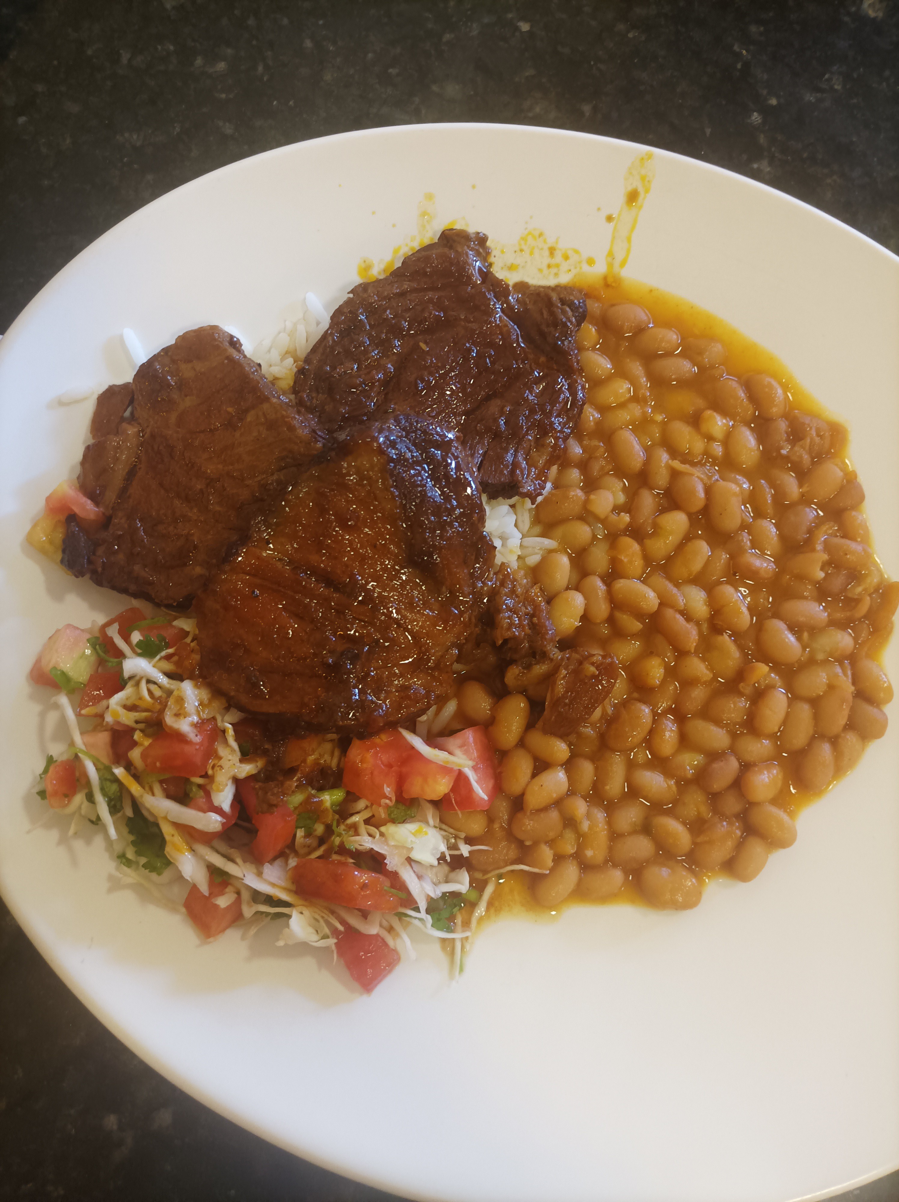 Steak, beans, rice, salad