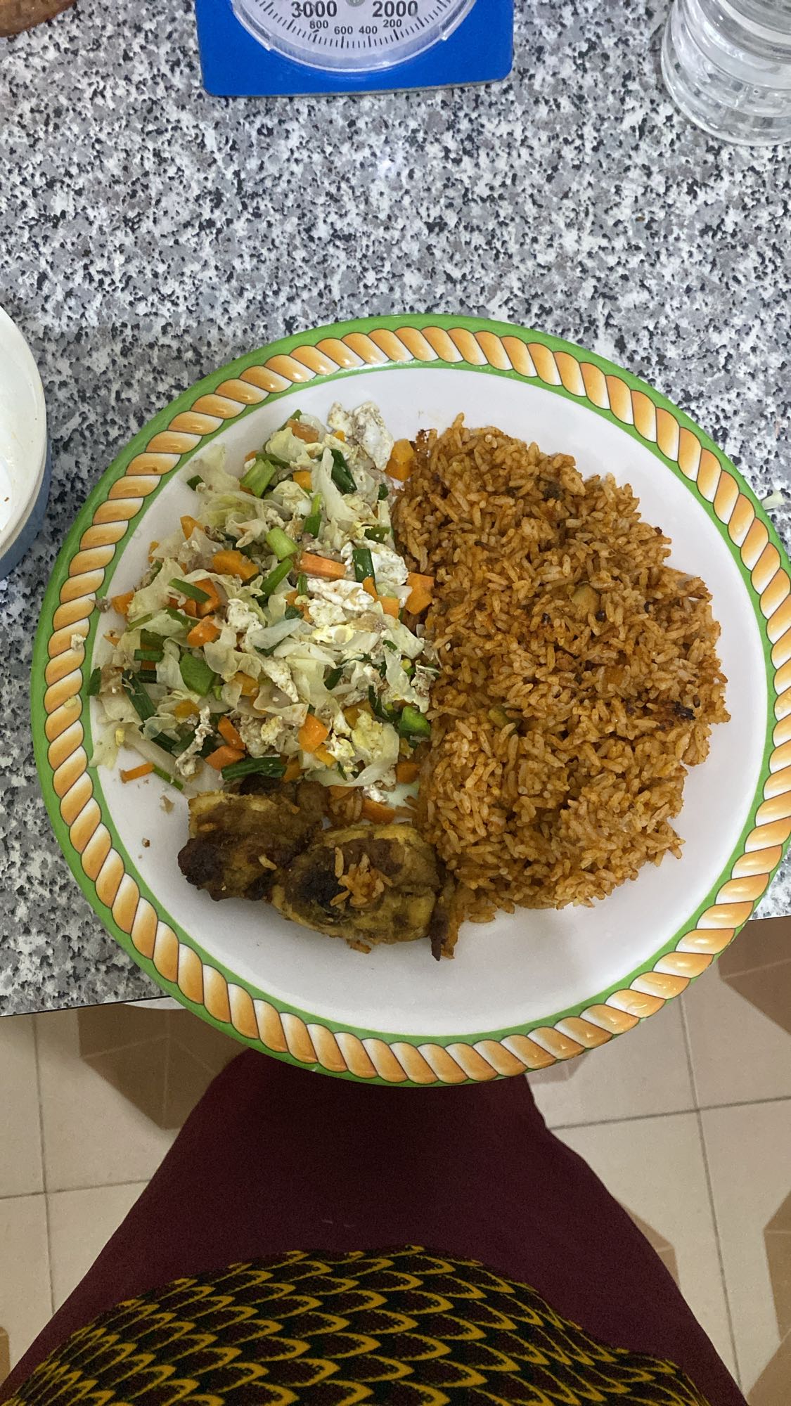 Jollof rice with salad and chicken