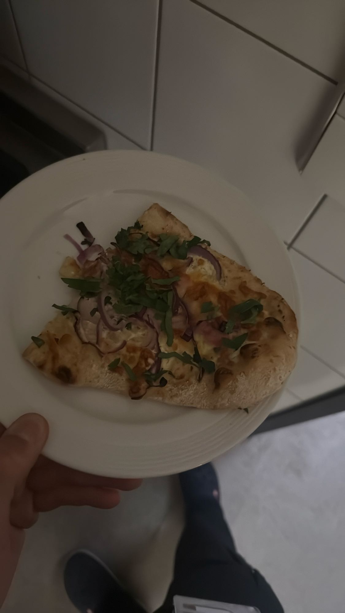 Pizza slice with greens