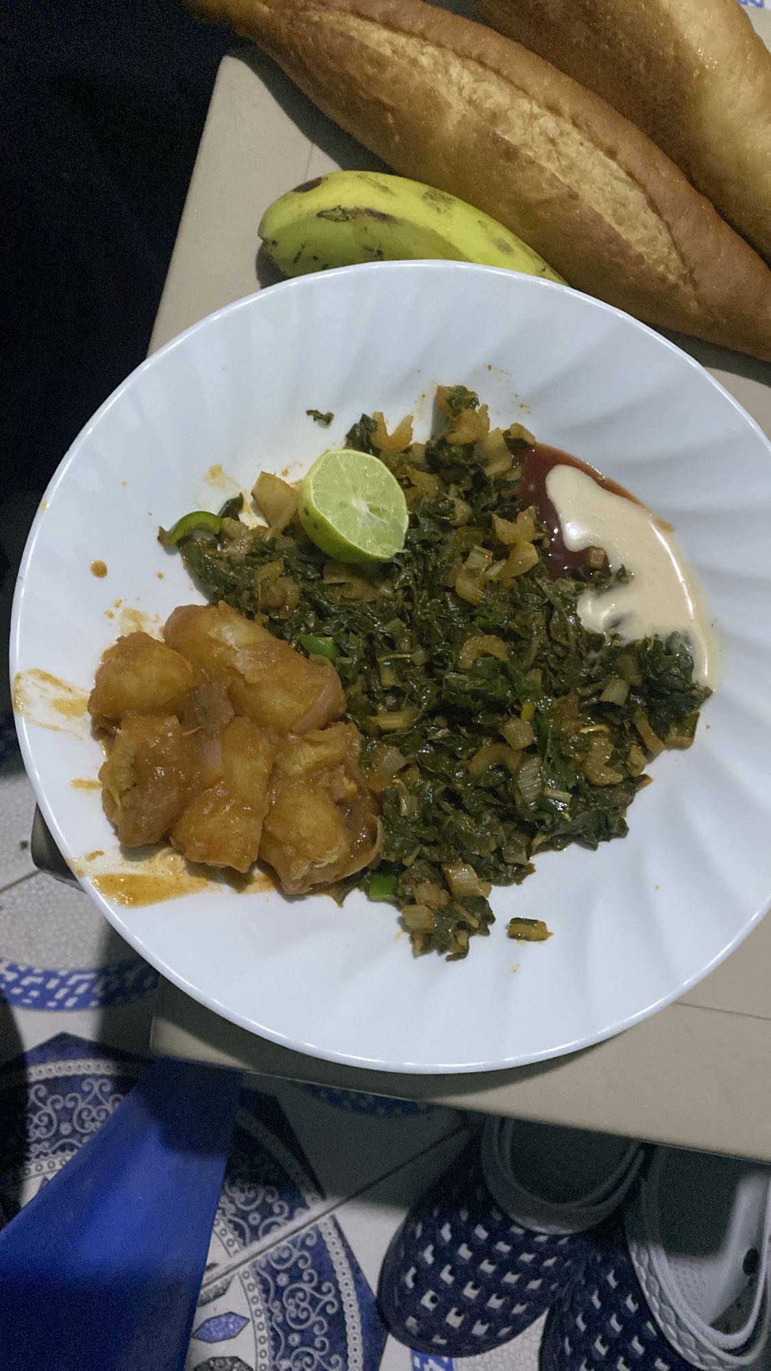 Leafy stew, yam, bread, banana