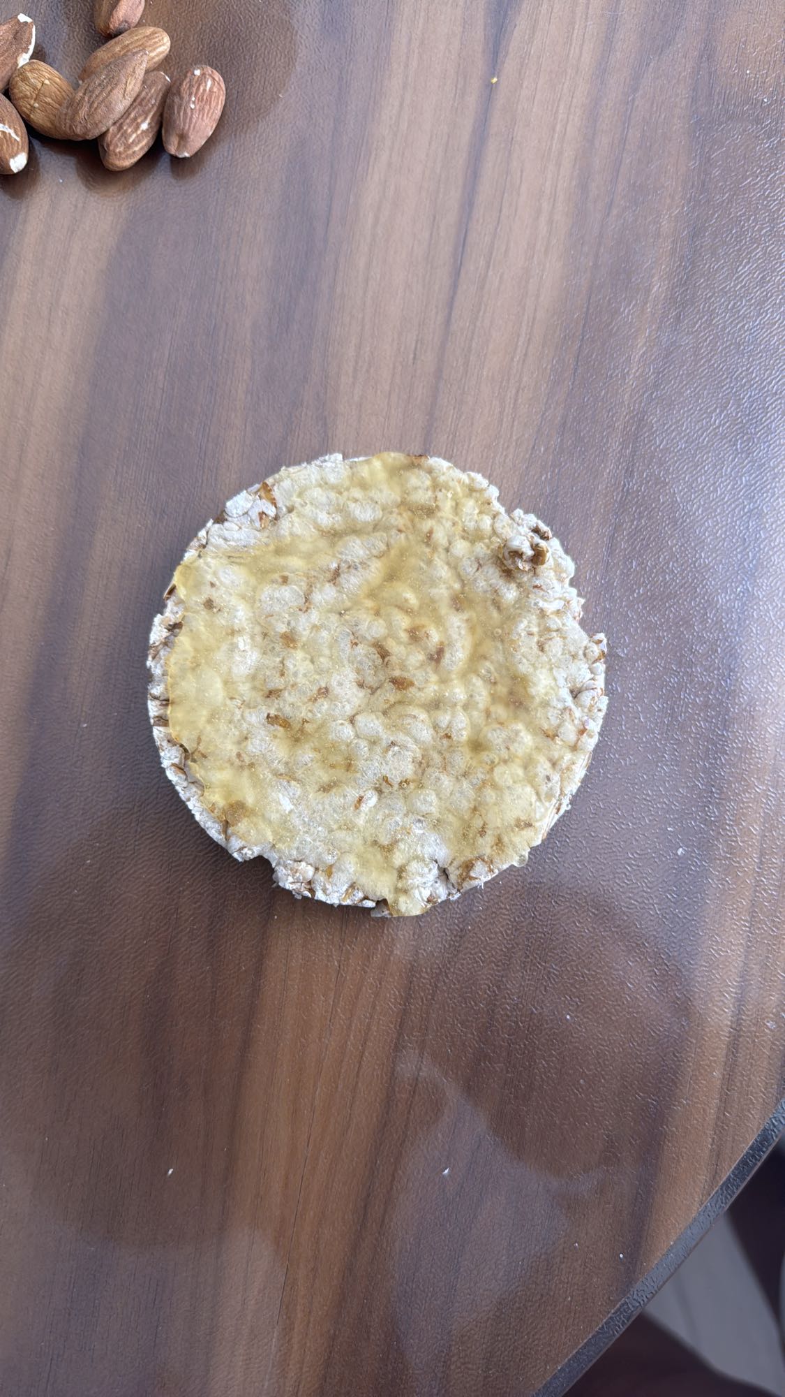 Rice cake with peanut butter and almonds