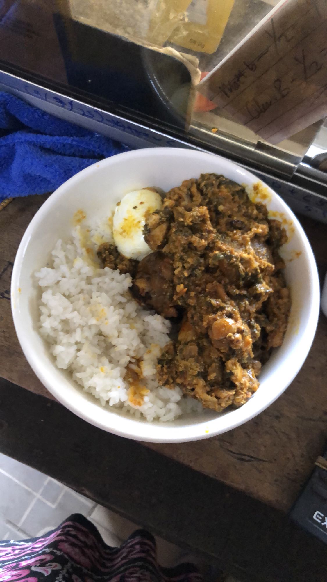 Rice with egusi soup and egg