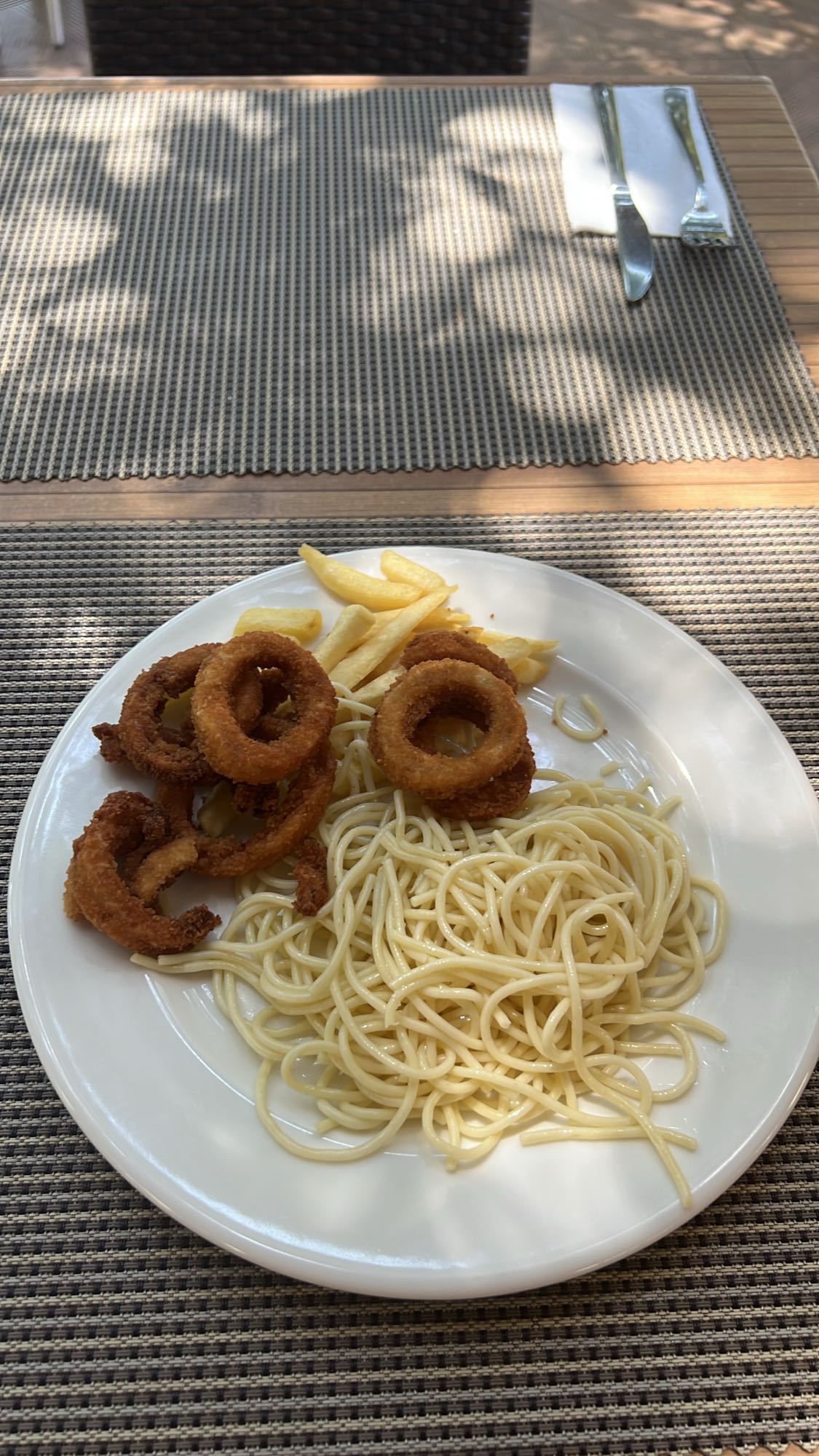 Pasta with onion rings and fries