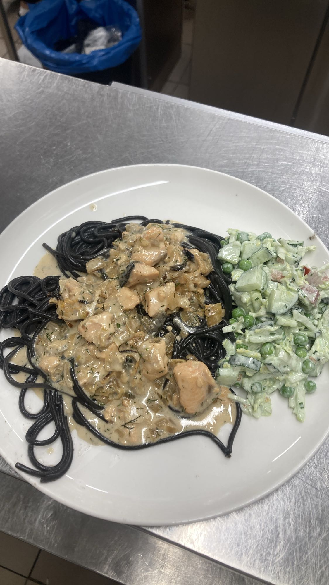 Black pasta with salmon & salad