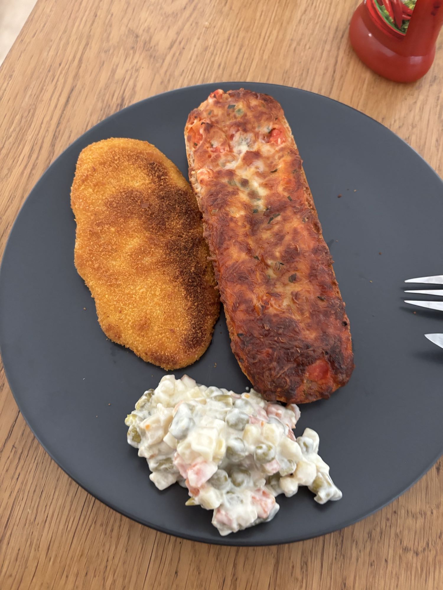 Breaded cutlet, pizza bread, salad