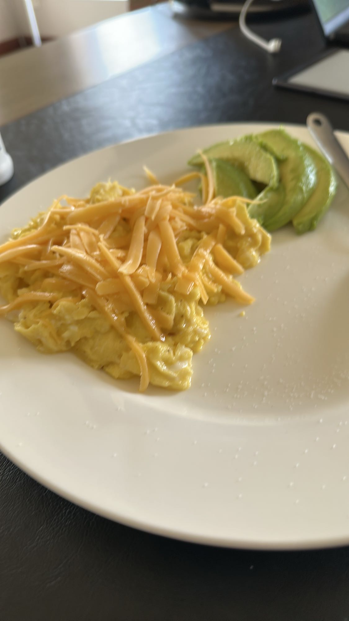 Scrambled eggs with cheese and avocado