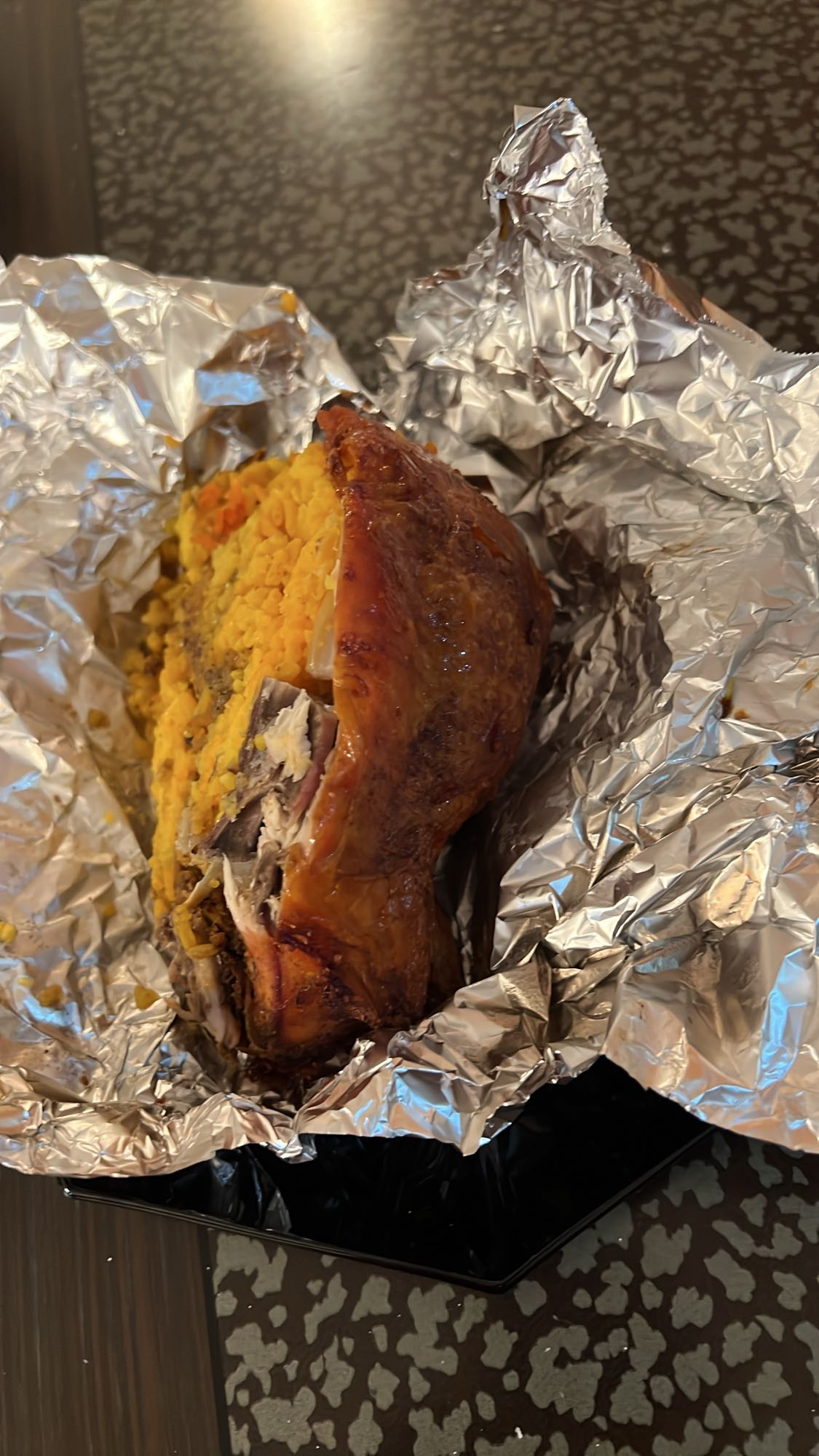 Half chicken stuffed with rice and turmeric