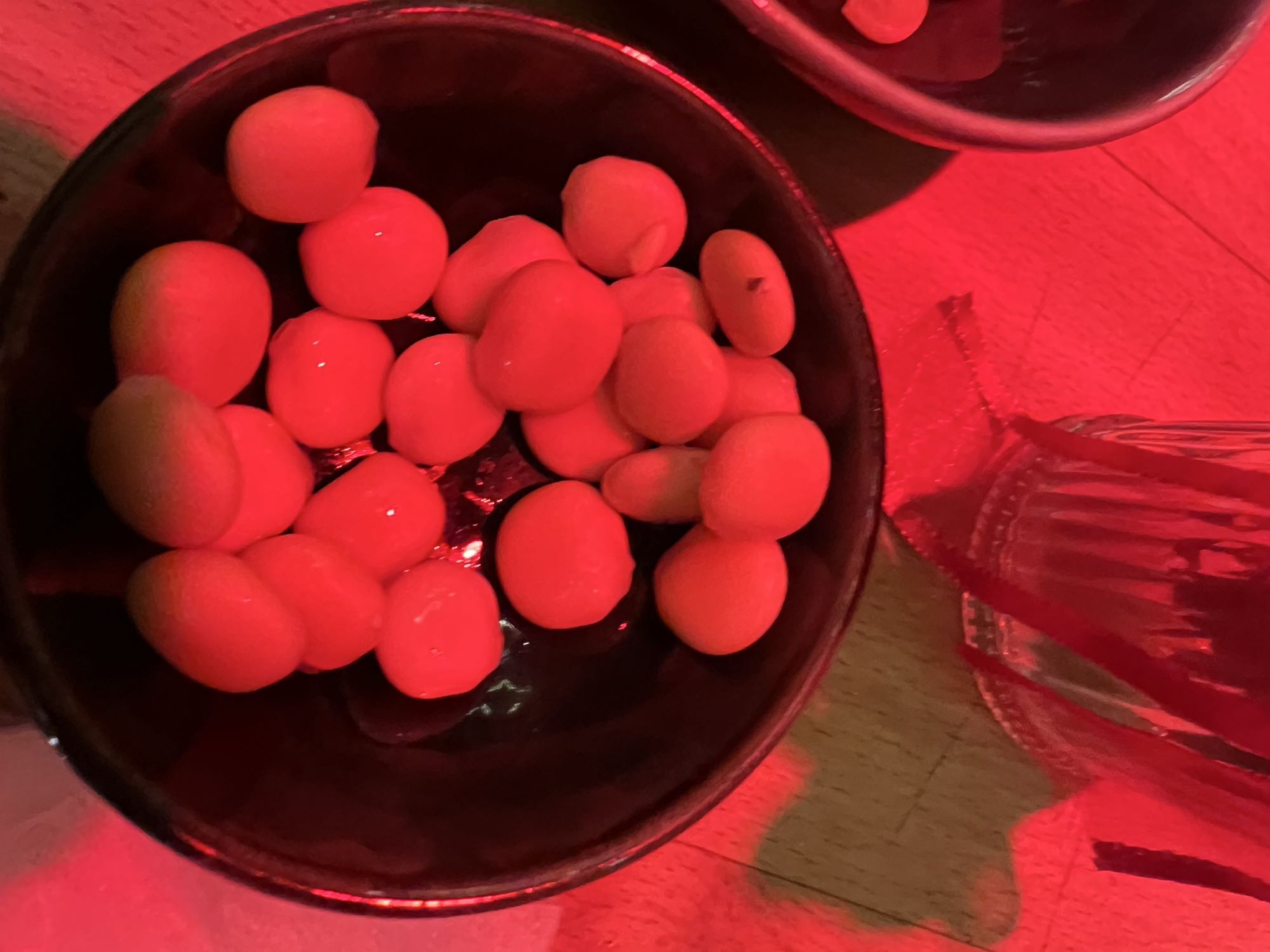 Bowl of green olives with 10 lupin grains