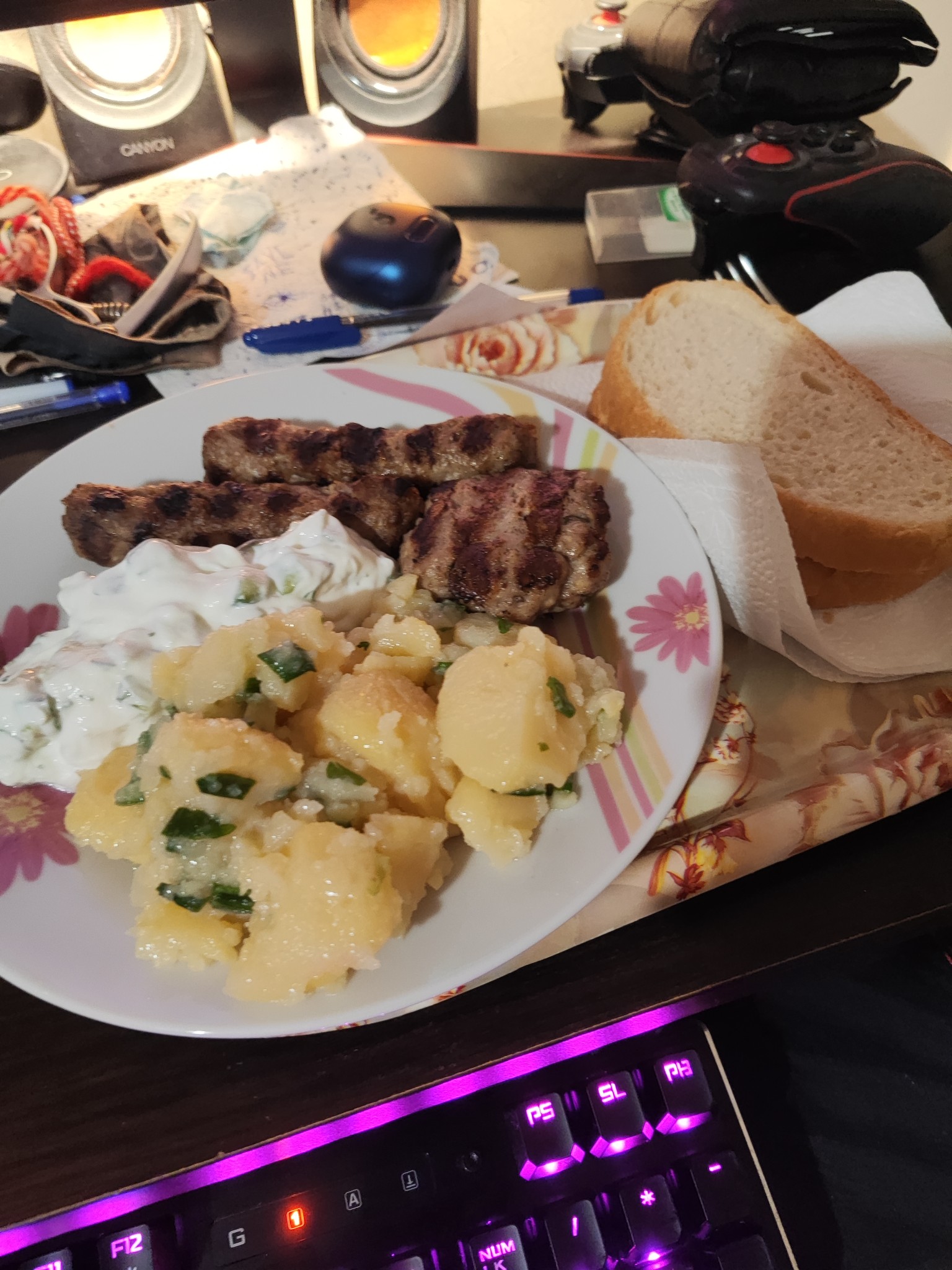 Grilled meat, potato salad, bread
