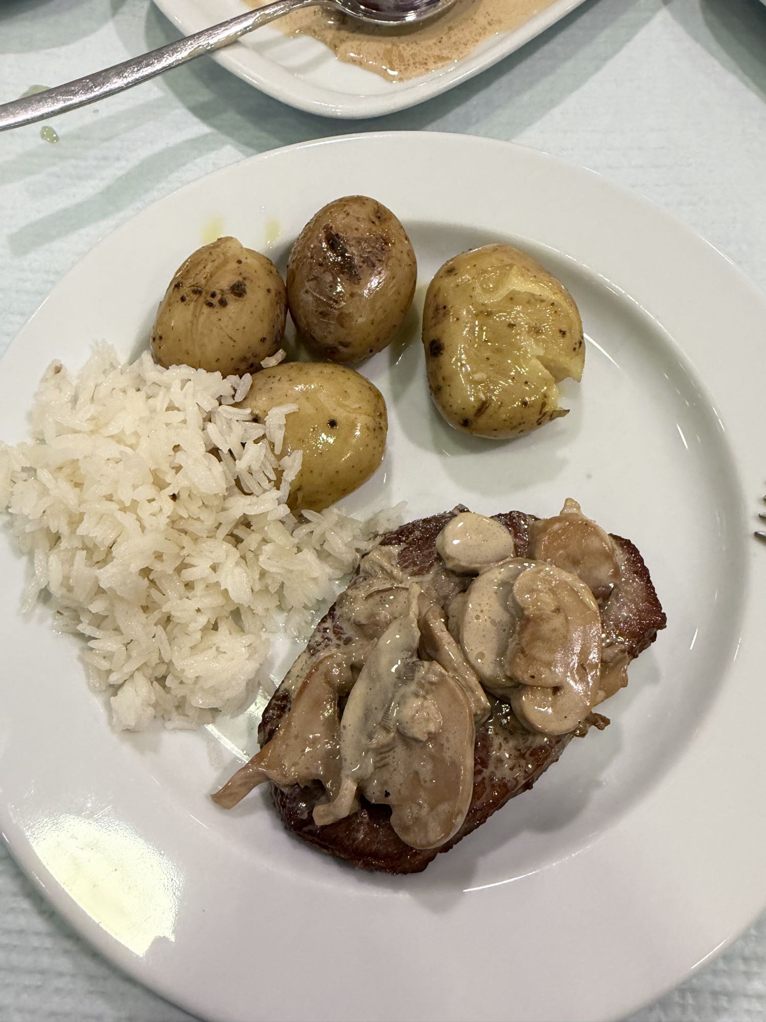 Steak with potatoes and rice
