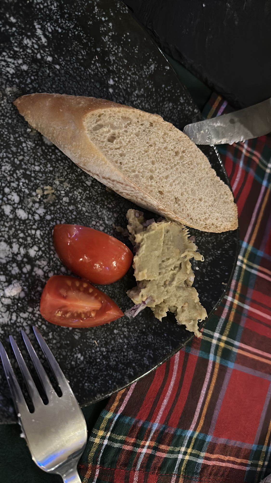 Bread, hummus, tomato plate