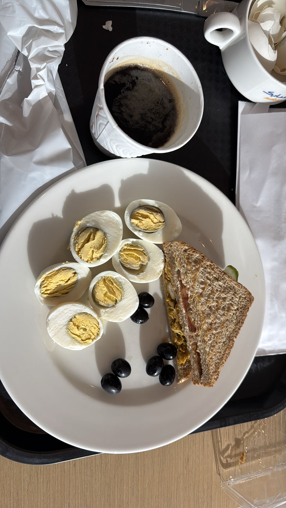 Eggs, sandwich, olives, coffee