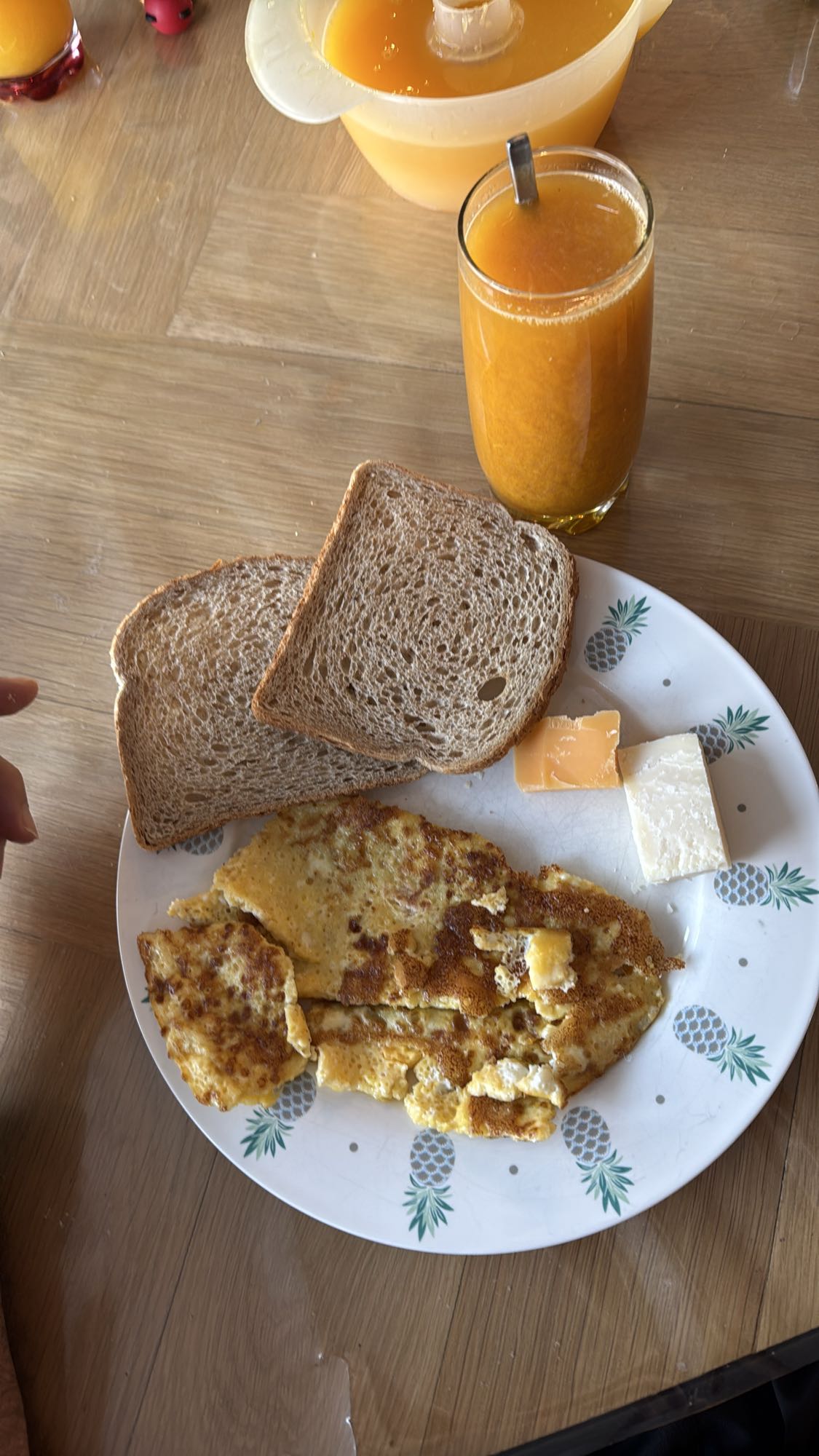 Omelette, bread, cheese, juice