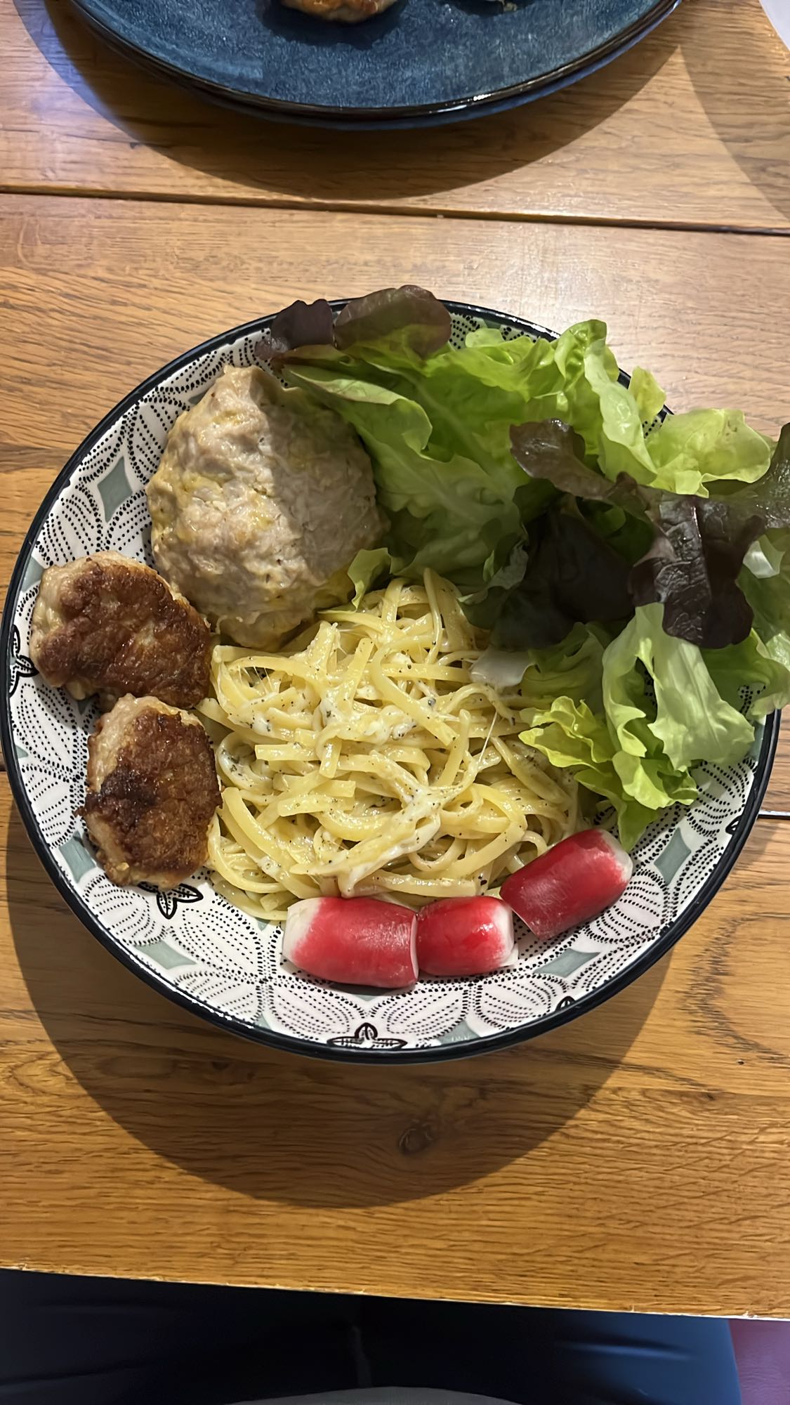 Pasta with patties and salad