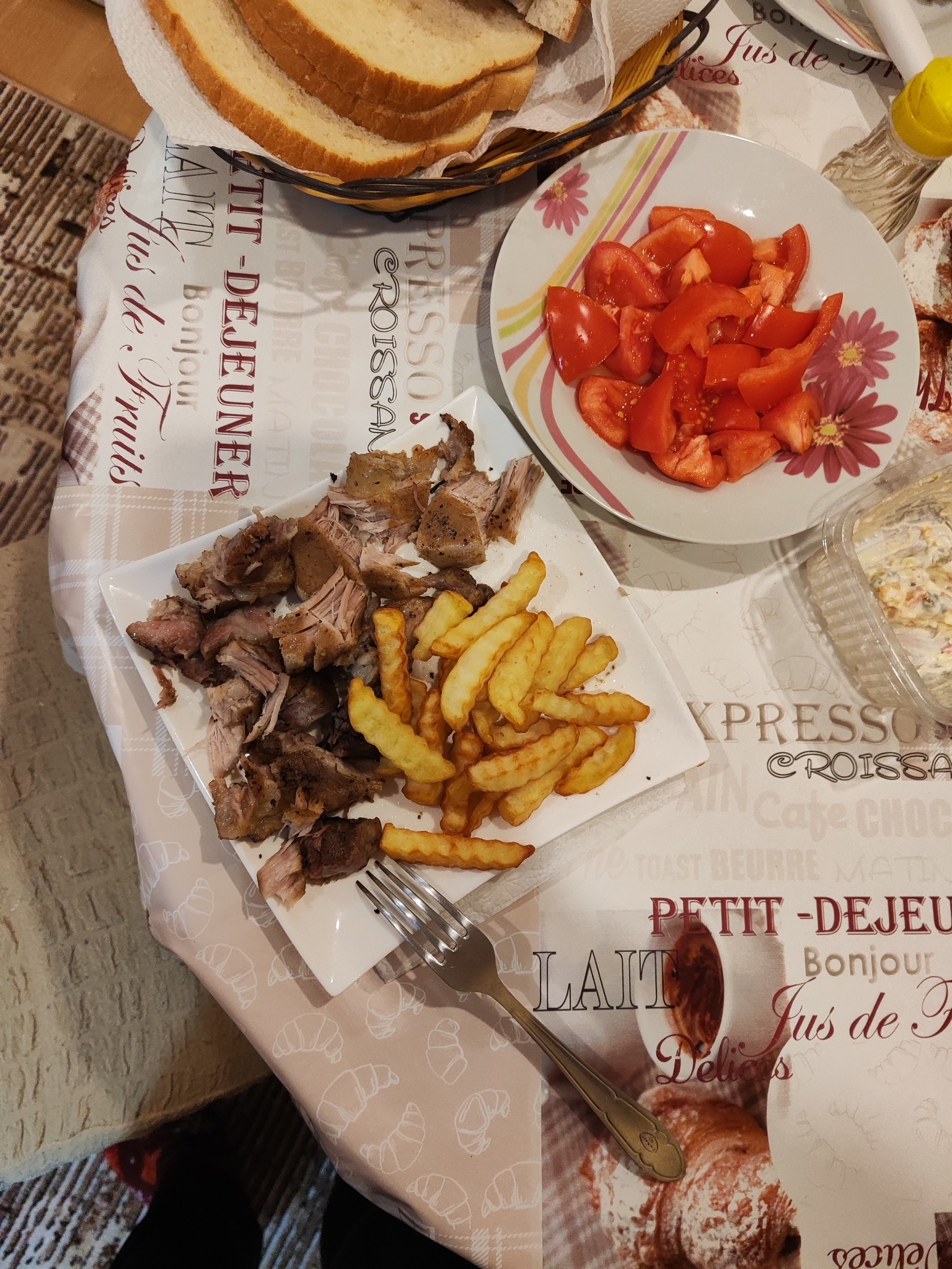 Roast pork, fries, bread, tomato