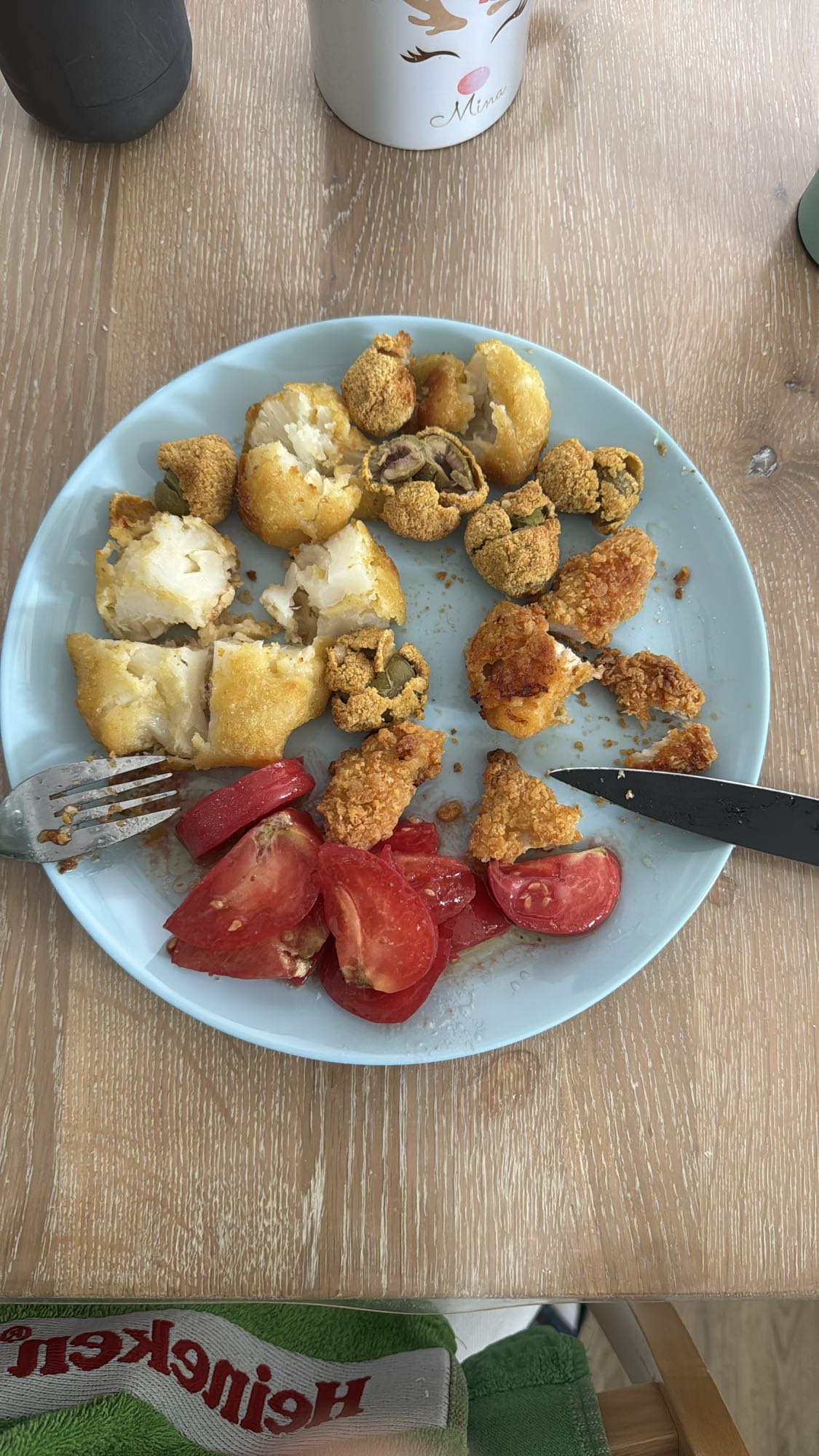 Breaded cauliflower, breaded olives, crispy chicken, and one tomato